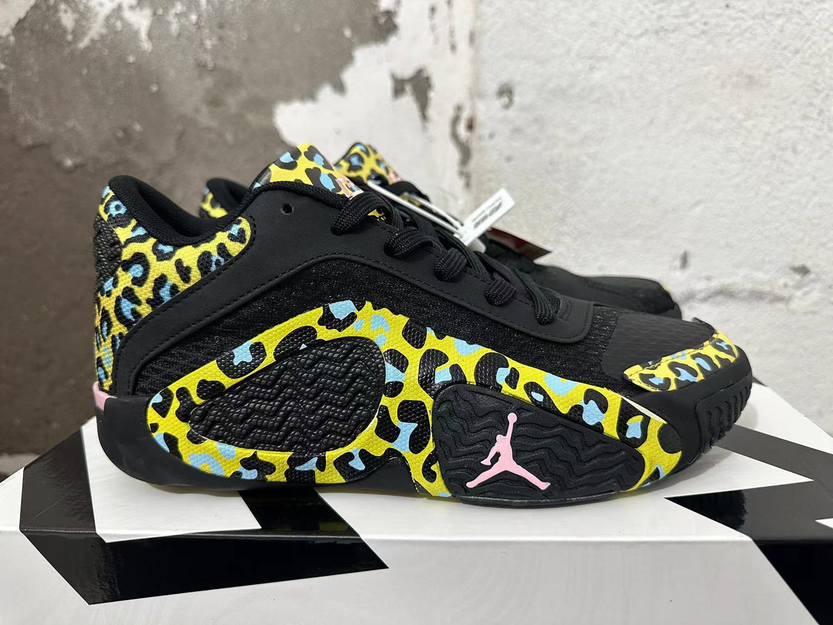 Side view of a Jordan Luka 1 shoe showing patterned panels and pink Jumpman detail