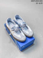 Pale blue adidas Samba Jane Mary Jane sneakers with a strap, shown on a blue shoebox.