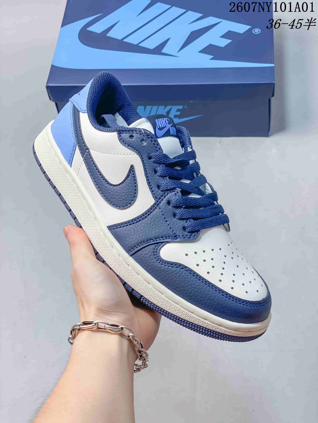 Angled close-up of the white and blue sneaker upper