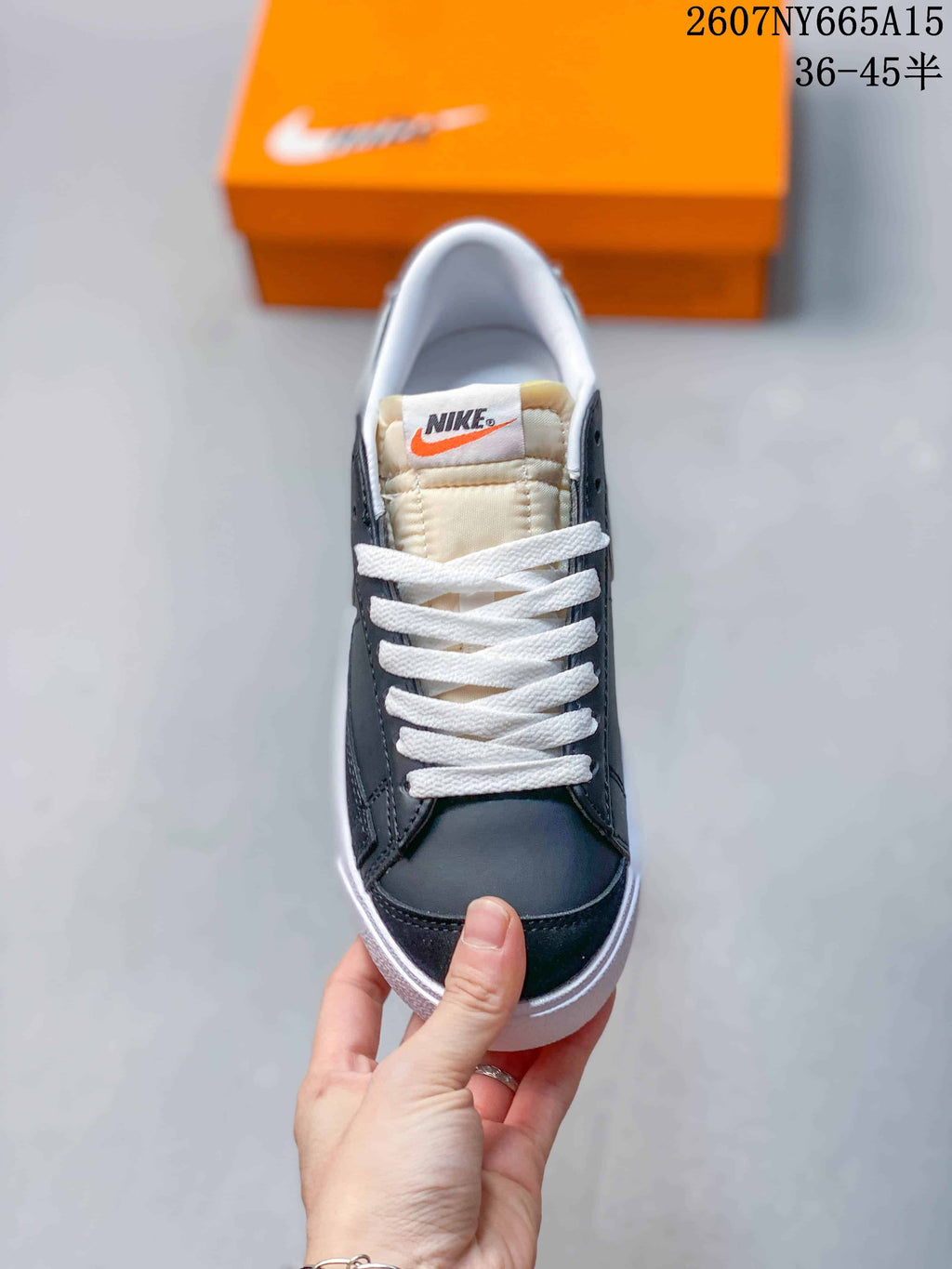 Top view of the sneaker showing the black toe, white laces, and padded tongue.