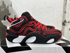 Side view of a black-and-red Jordan Tatum 1 basketball shoe with light-colored sole details