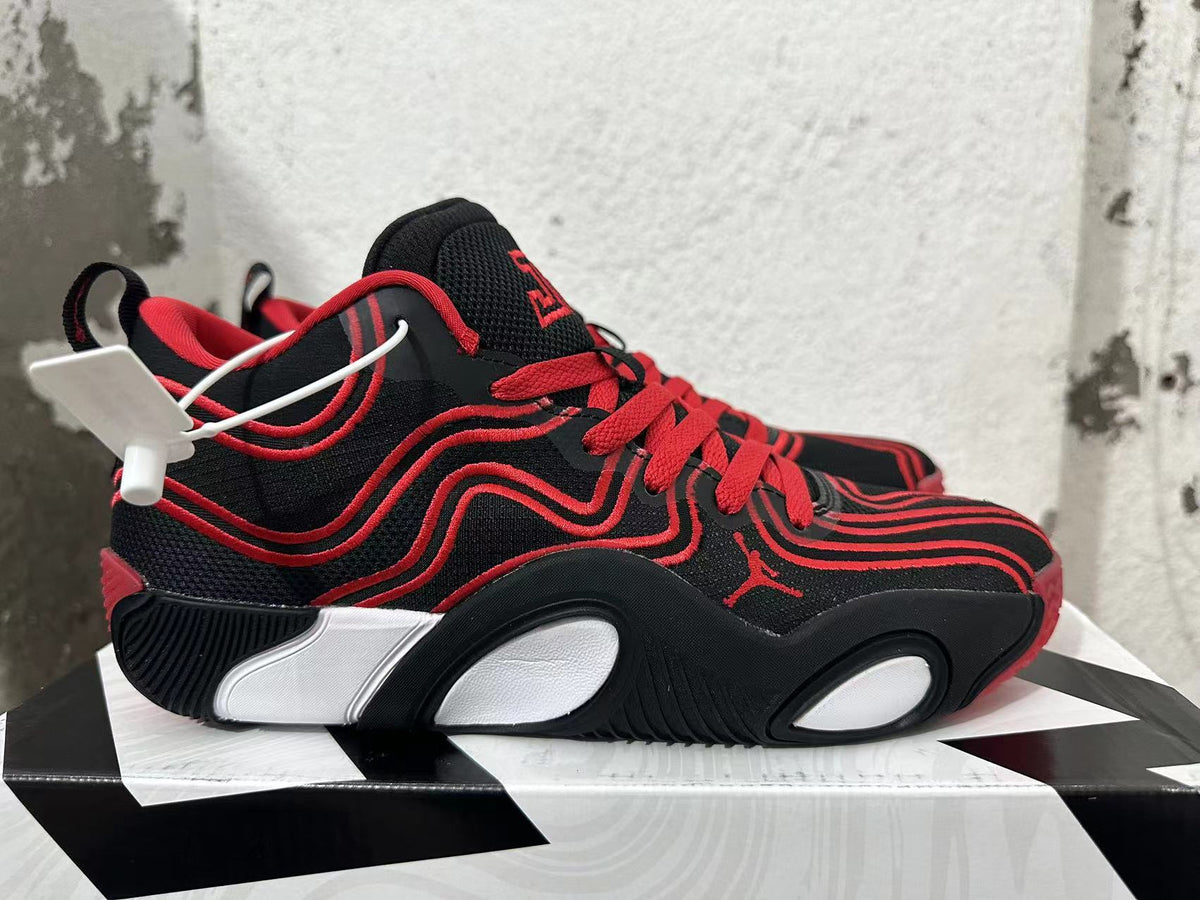 Side view of a black-and-red Jordan Tatum 1 basketball shoe with light-colored sole details