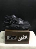 Side view of black Jordan Jumpman Jack sneakers showing white contrast stitching, lateral Swoosh and forefoot straps.