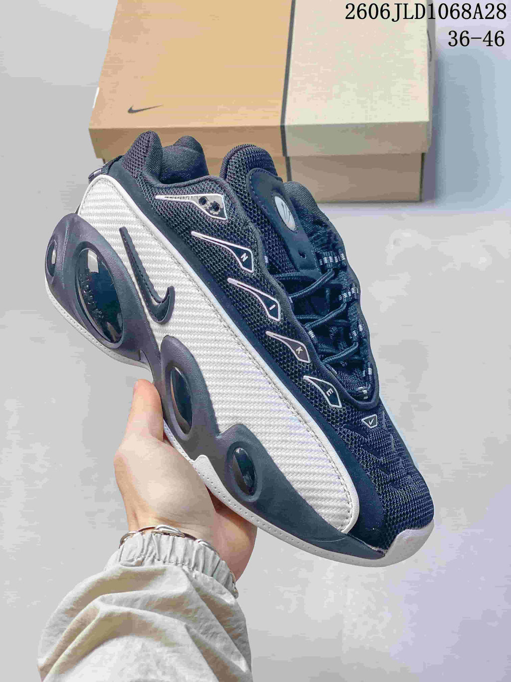 Angled side view of a black and white Nike NOCTA Glide sneaker.