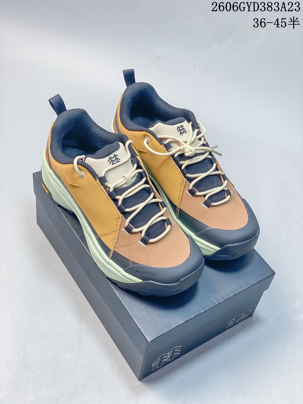 Pair of Kolon Sport low-top hiking shoes in mustard yellow, tan, navy, and pale green, shown from above at an angle.