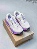 Pair of white On Cloudtilt sneakers with purple accents displayed on a shoe box.