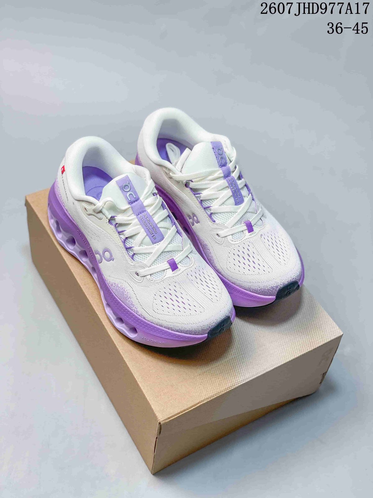 Pair of white On Cloudtilt sneakers with purple accents displayed on a shoe box.