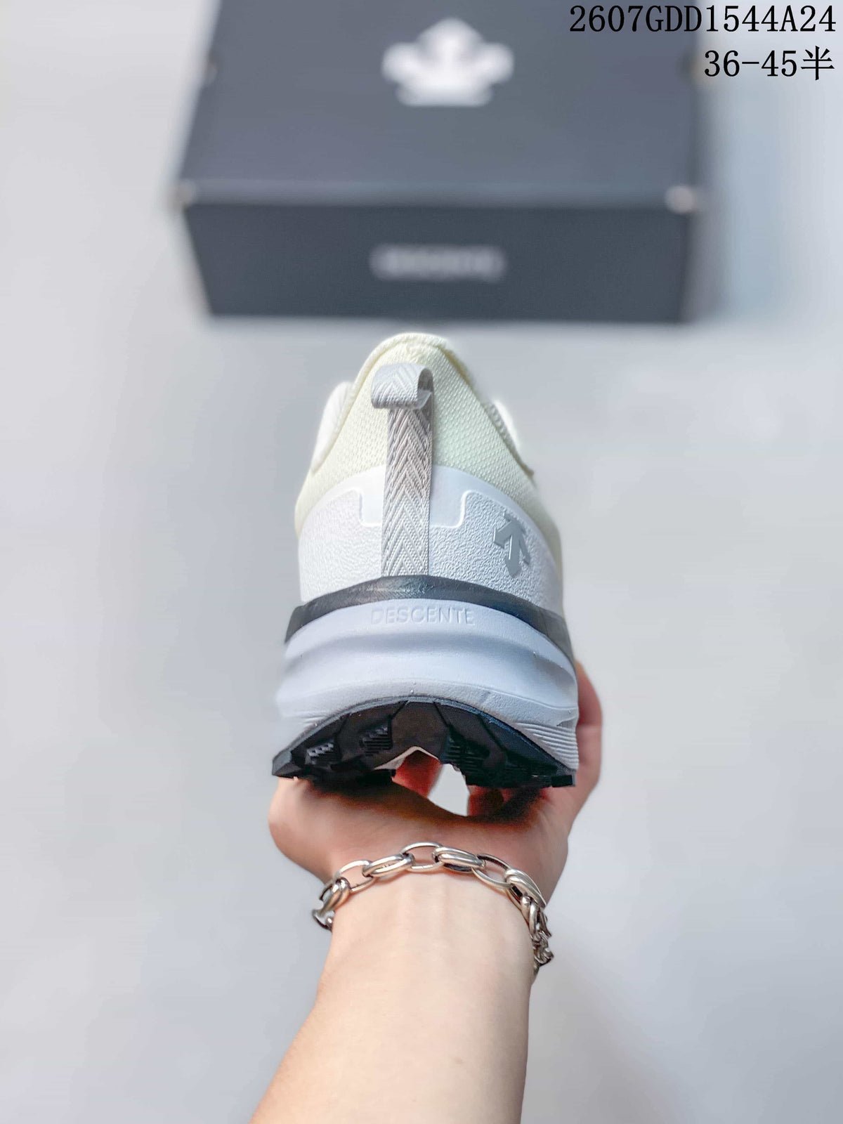 Rear view of the sneaker showing the heel pull tab, layered heel structure, DESCENTE branding, and black outsole edge.