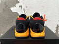 Rear view of black and yellow Kobe basketball shoes with red heel accents and signature graphics