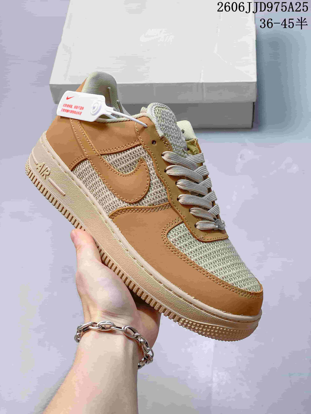 Angled side view of the tan and cream low-top sneaker showing the side branding, woven-texture panels, layered upper, and textured outsole.