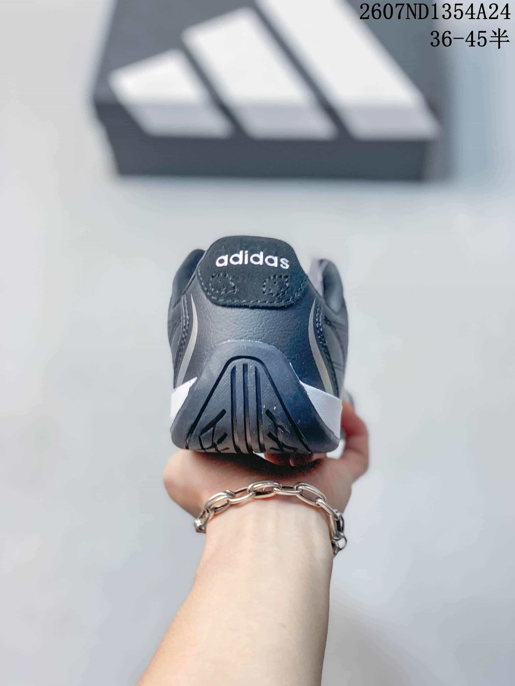 Rear view showing the heel structure, outsole pattern and adidas branding.