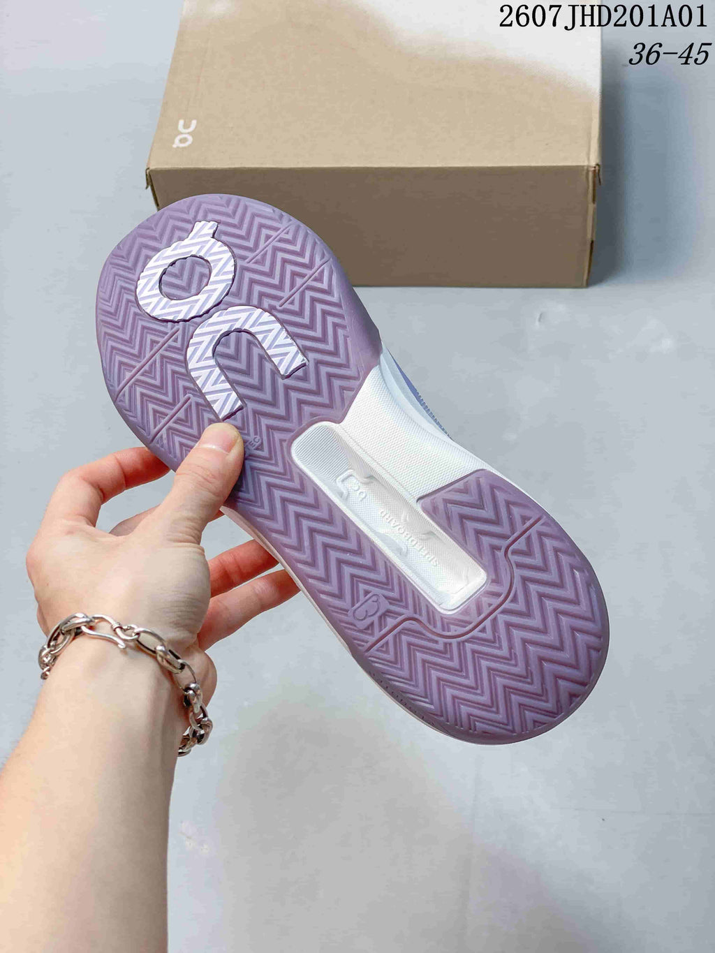 Underside of a lavender tennis shoe showing a patterned outsole; image overlay shows code 2607JHD201A01 and sizes 36–45.