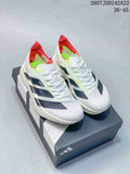 Pair of white Y-3 Adios Pro 4 sneakers with black side details, neon green accents, red collars, and a shoe box.