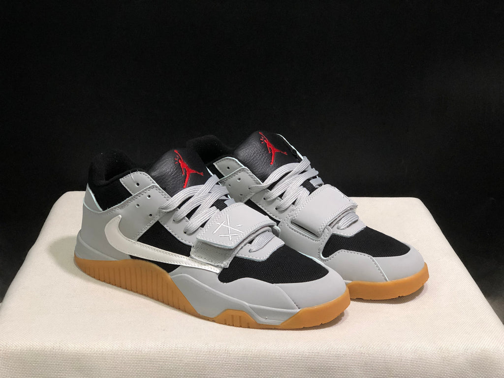 Three-quarter product view showing the pair's black and white construction, laces, straps, and gum-colored soles.