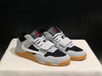 Three-quarter product view showing the pair's black and white construction, laces, straps, and gum-colored soles.