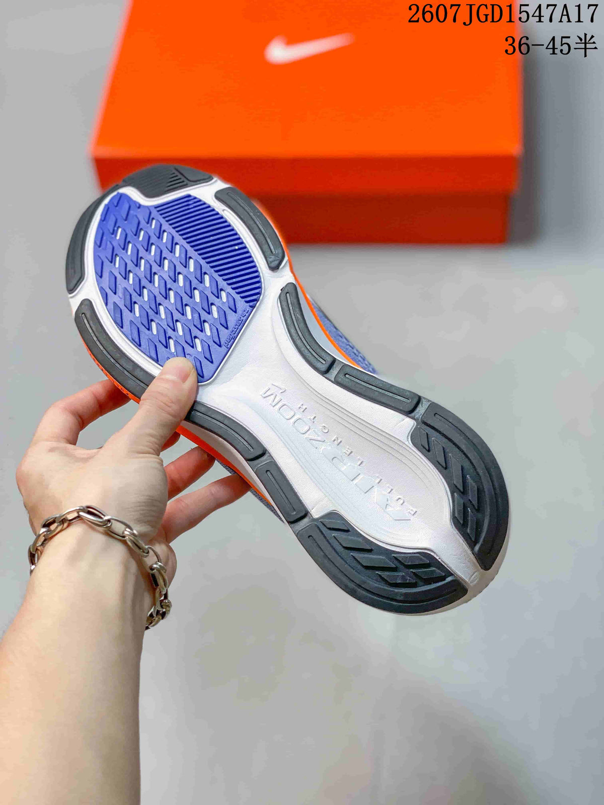 Nike Pegasus 42 outsole shown from below, featuring blue tread sections and black rubber segments.