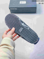 Bottom view of the sneaker showing the textured repeating outsole pattern and an Onitsuka Tiger shoebox.