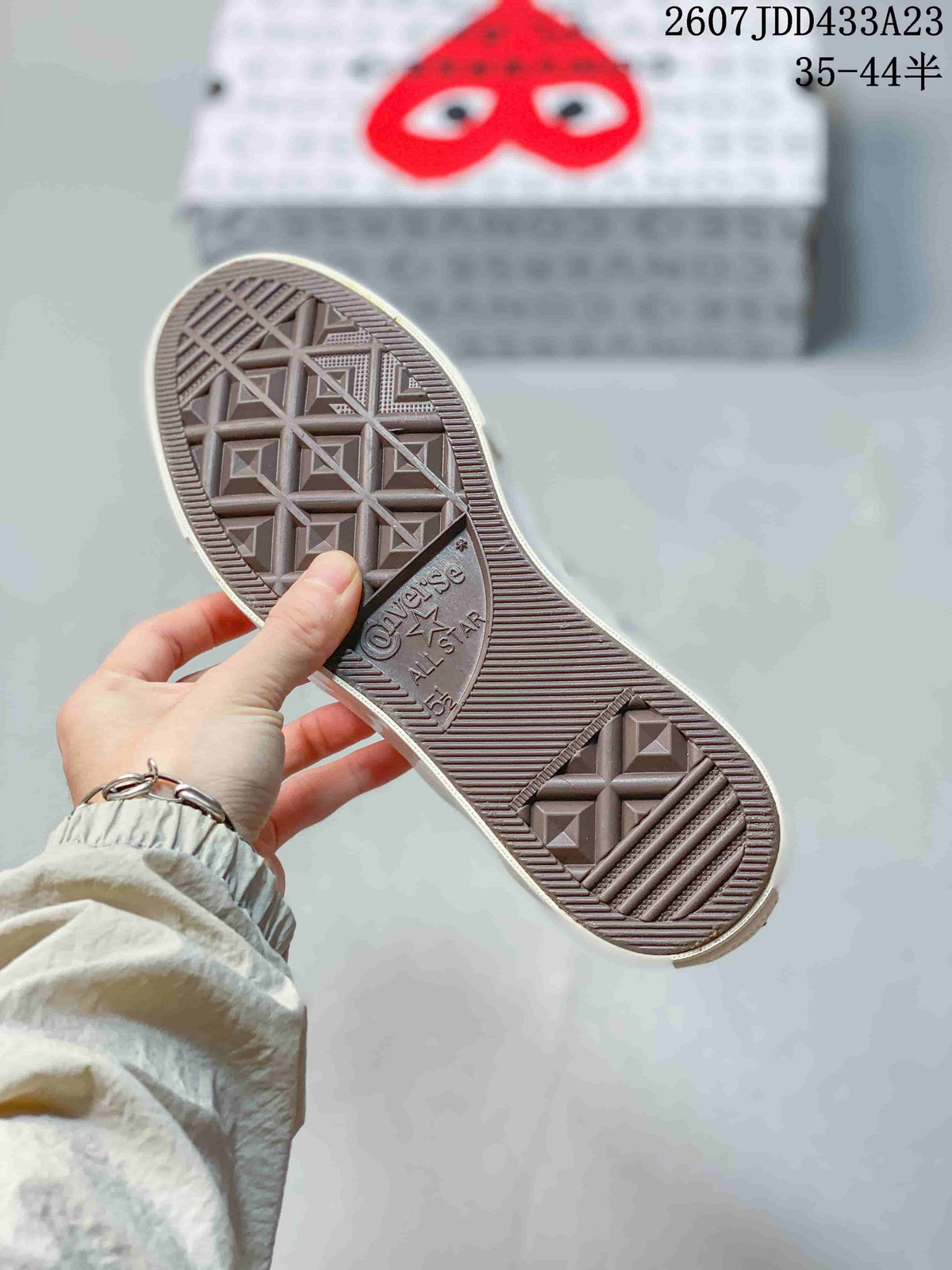 Close view of the sneaker's patterned rubber outsole with Converse branding.