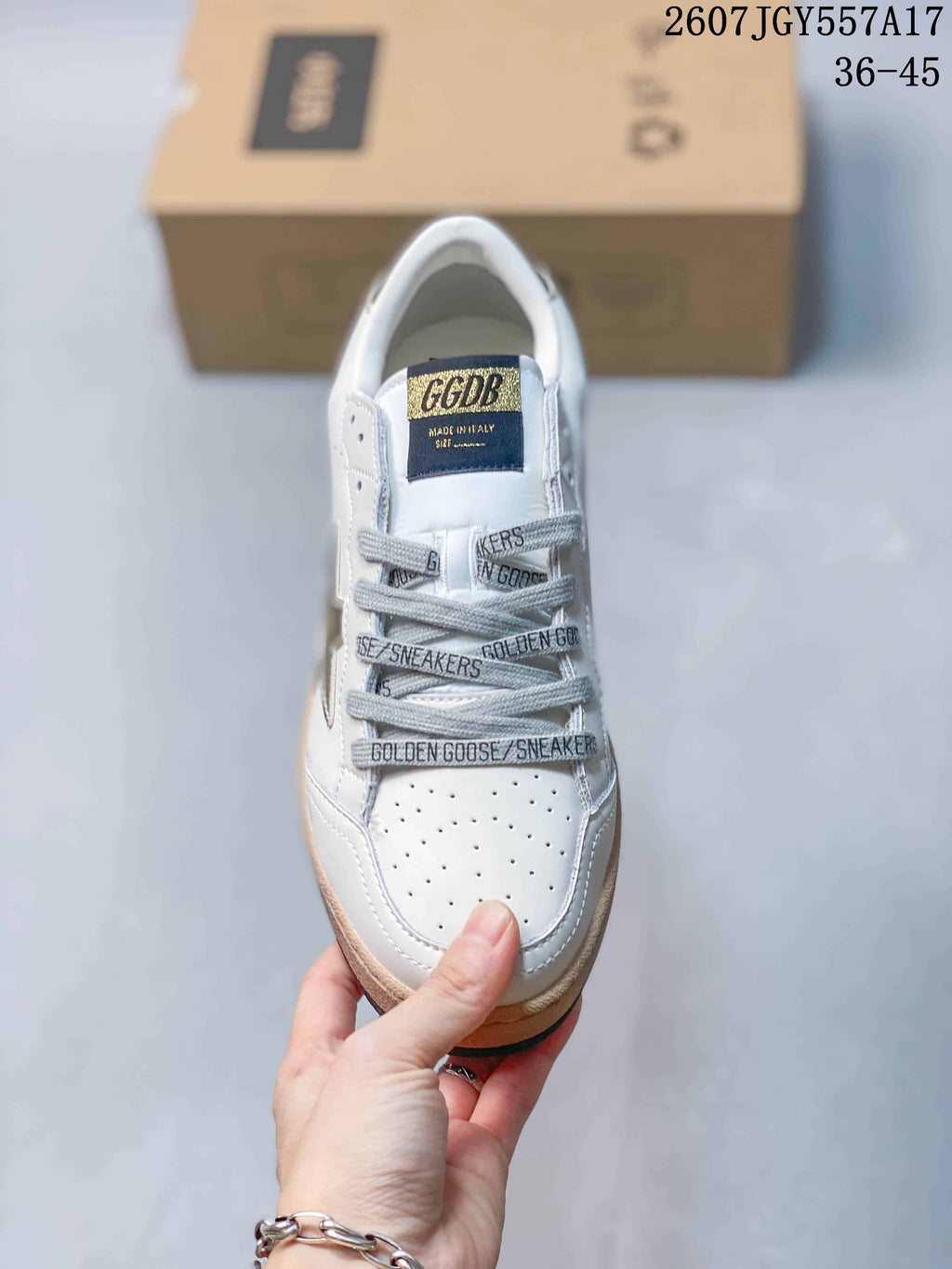 Top view showing the perforated toe, gray laces, and branded tongue label.