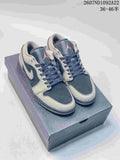 Pair of gray and navy low-top Jordan sneakers displayed on a shoe box, with the printed style code and size range visible above.
