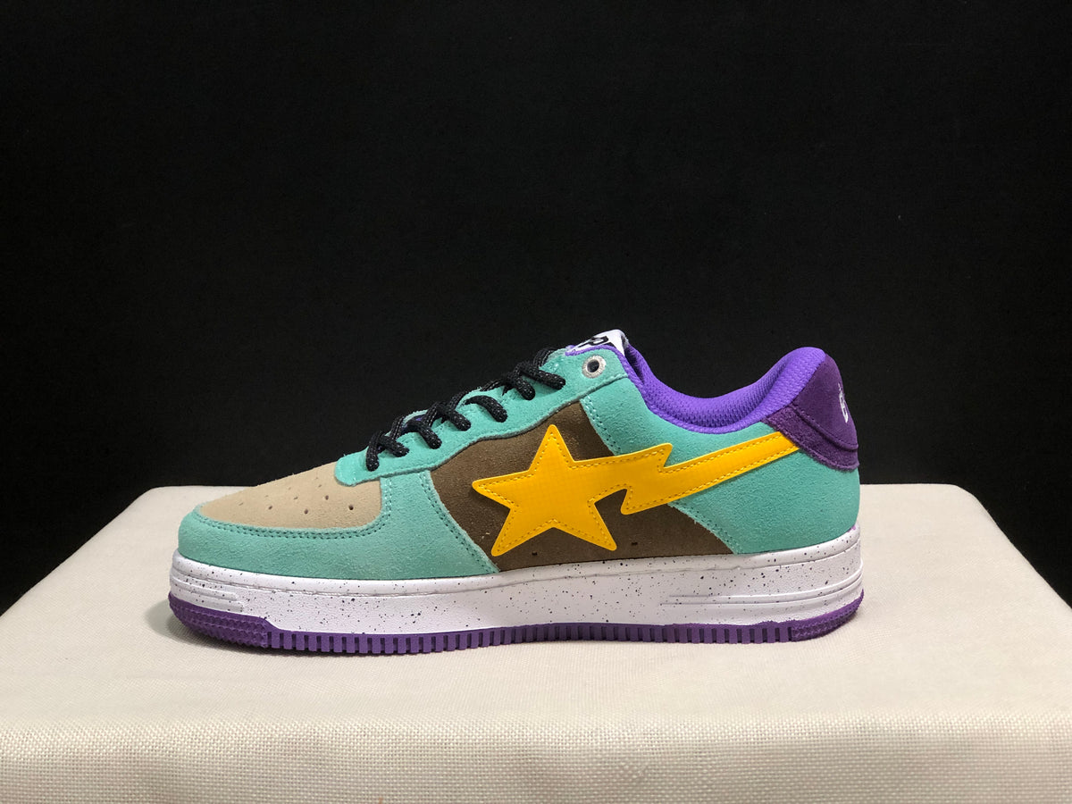Side profile showing the yellow star-shaped side mark, mint green panels, brown central section, purple heel detail, and speckled midsole.