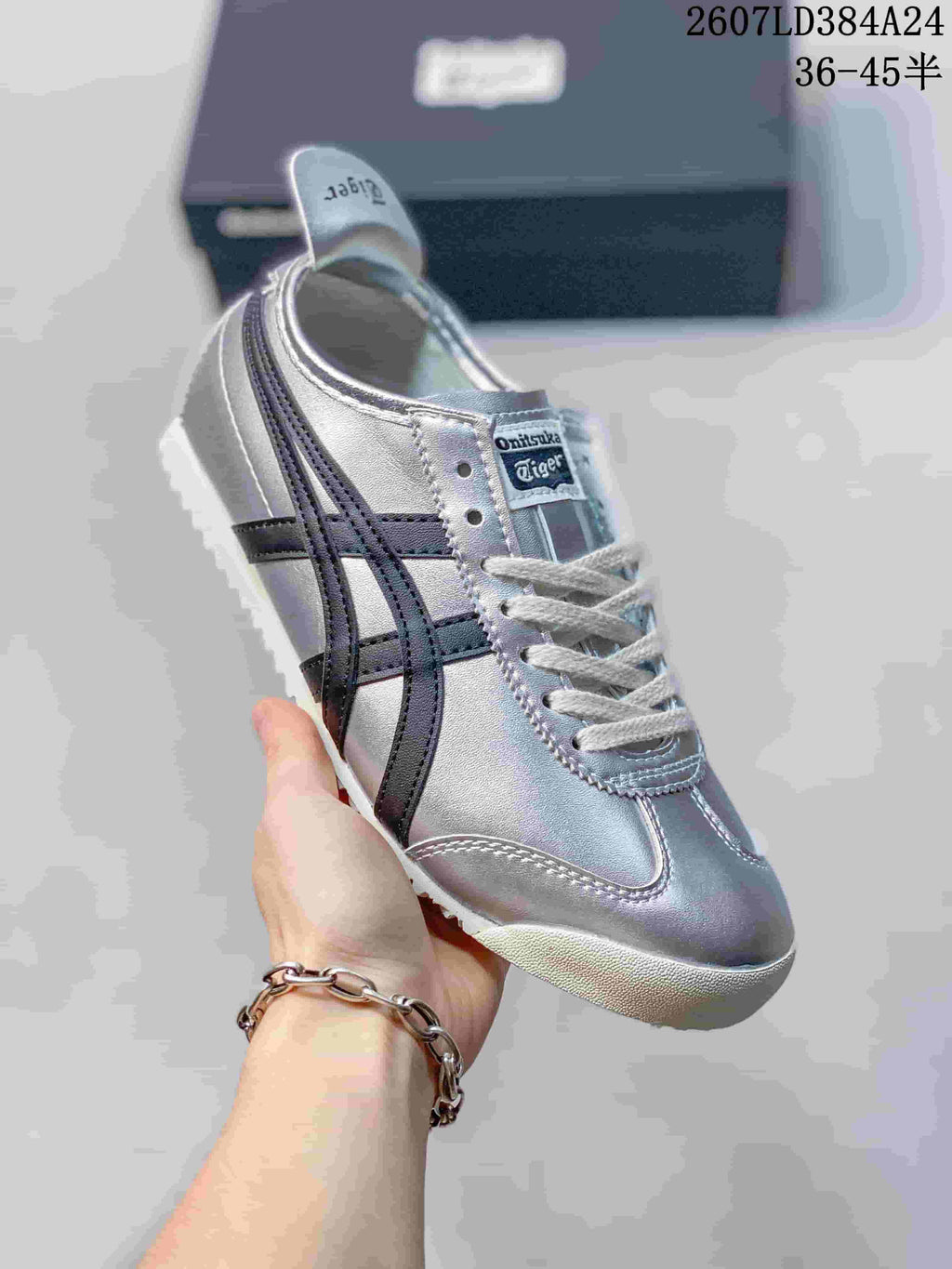 Angled side view showing the silver and black sneaker design with white sole.