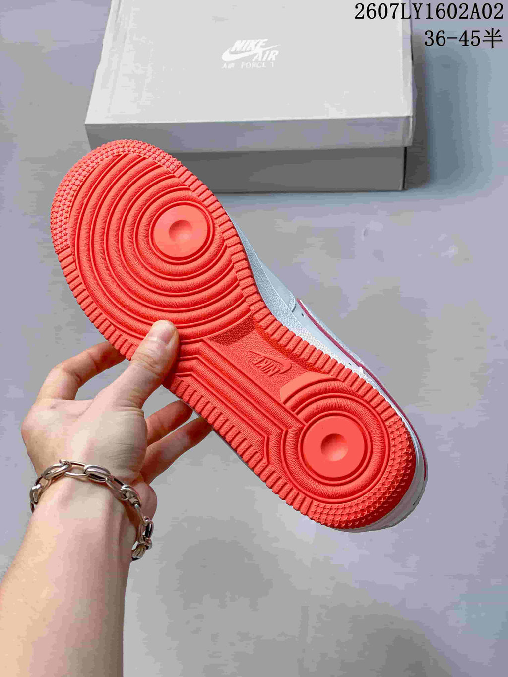 Close-up of the red textured outsole on a Nike Air Force 1 ’07 sneaker.