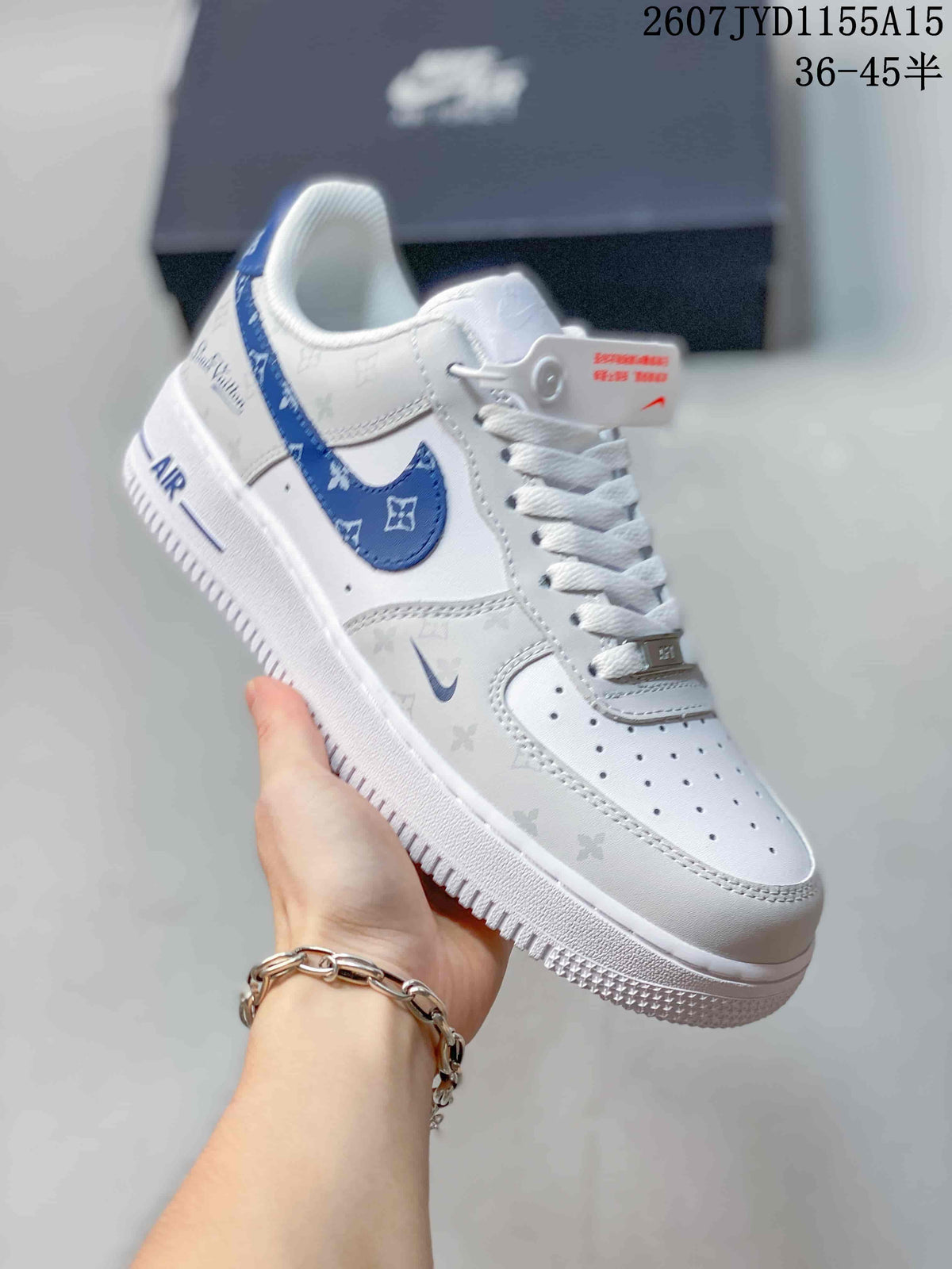 Angled side view showing the blue patterned Swoosh, tonal upper motifs, and AIR outsole branding.