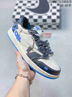 Side view of a white, black and blue low-top sneaker showing layered overlays, patterned laces, a decorative hangtag and blue outsole.