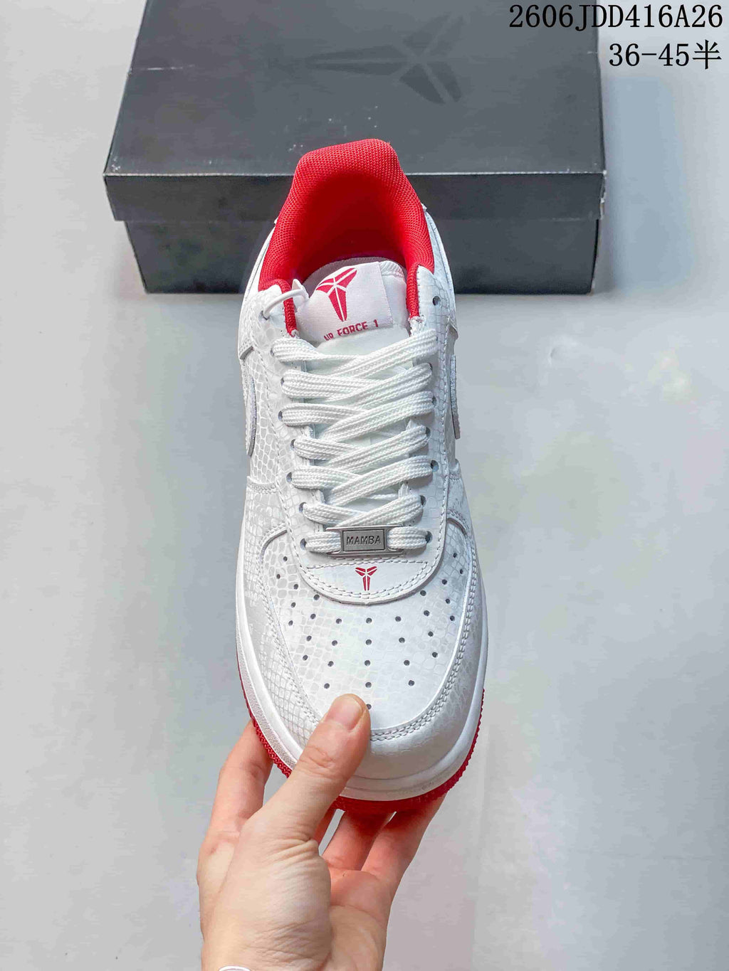 Front view highlighting the perforated toe, white laces, and red collar lining.