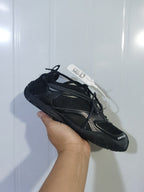 Angled front and side view of the black Balenciaga Radar sneaker, showing the mesh upper, tonal overlays, laces, and textured toe and outsole.