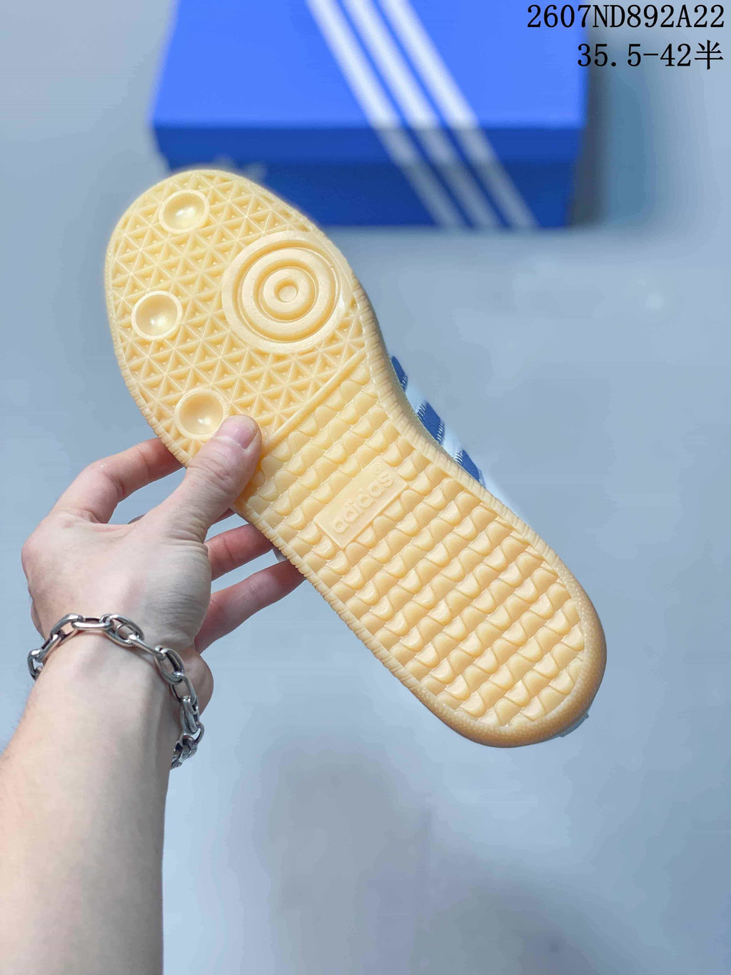 Close-up of the gum-colored outsole showing its textured tread pattern and adidas branding.