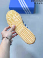 Close-up of the gum-colored outsole showing its textured tread pattern and adidas branding.