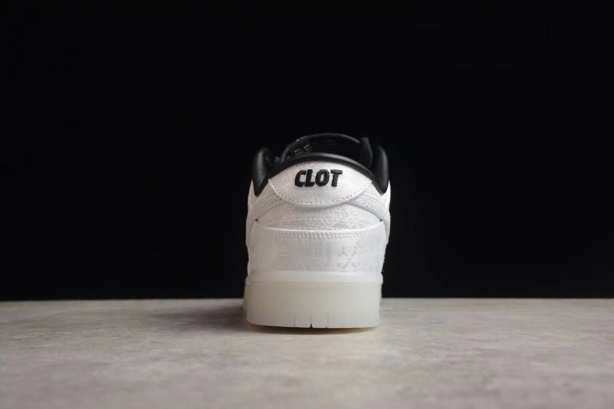 Rear view showing the white heel, black collar, CLOT branding, and white outsole.