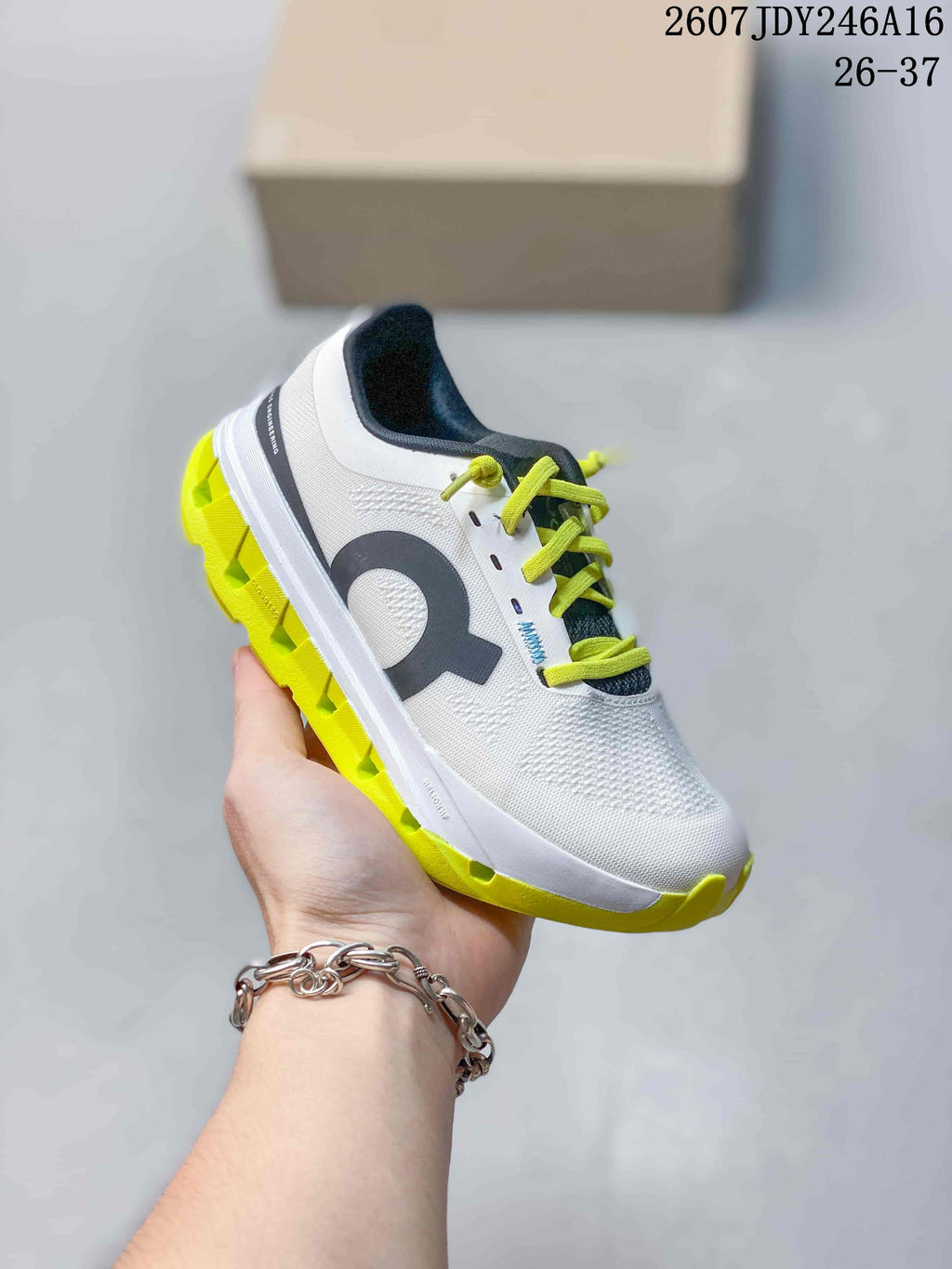 Side profile of the white On Cloudstratus 3 shoe with black side branding and a bright lime outsole.