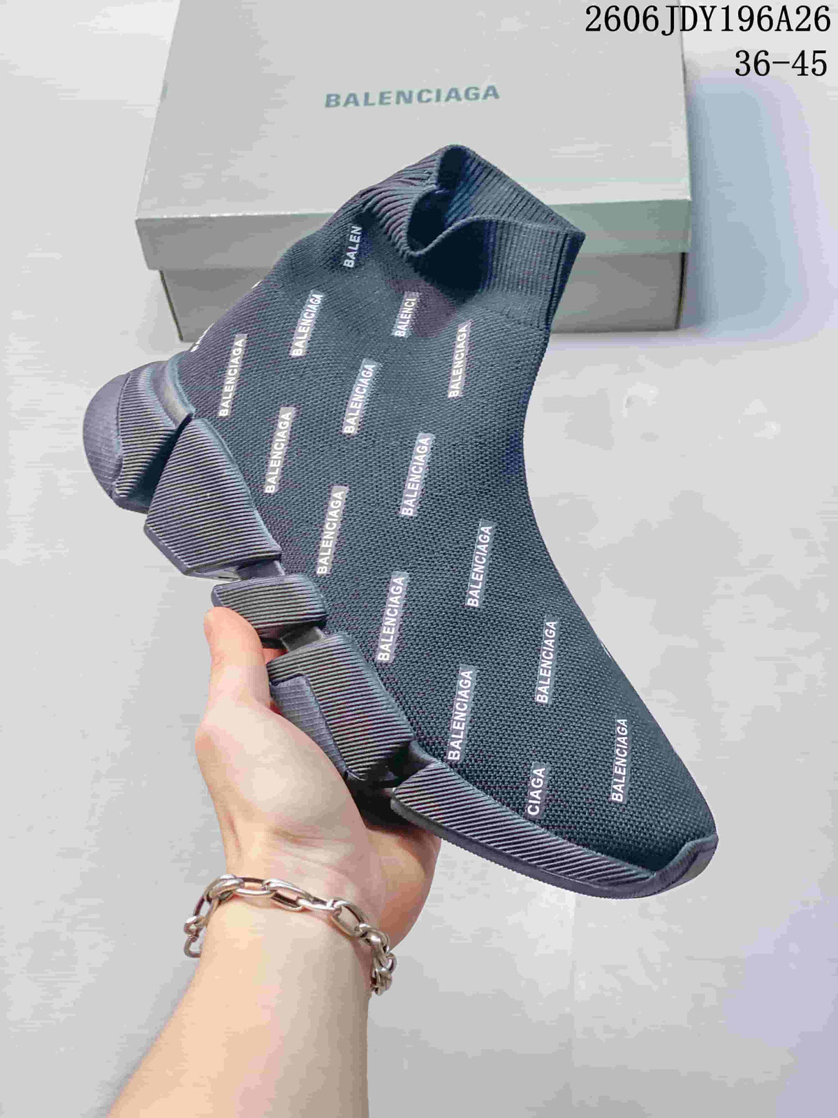 Close-up of a dark gray sock-style sneaker with repeating Balenciaga text and a sculpted sole.