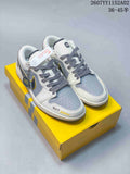 Pair of gray and white low-top sneakers with SU7 Ultra lettering on a yellow box