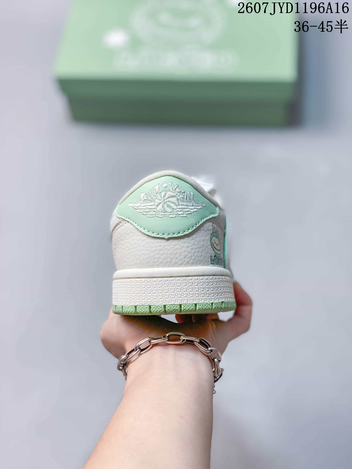 Rear view of the sneaker showing a mint green heel panel, white textured upper, and green outsole edge.