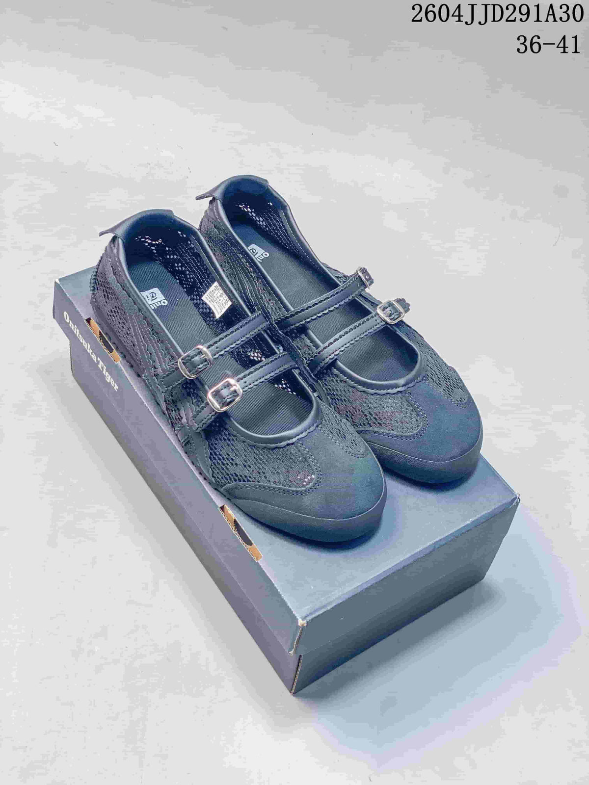 Pair of dark navy Mary Jane sneakers with two buckle straps