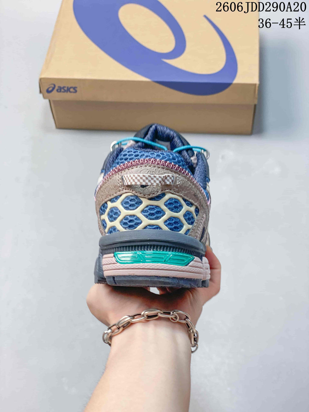 Rear view of the sneaker showing the padded heel, layered upper and textured outsole.
