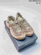 Pair of beige and muted green ECCO sneakers displayed on a branded shoe box; visible text shows style code 2607JWD845A25 and size range 38–45.