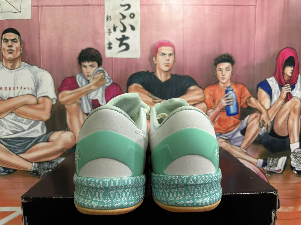 Rear view of mint, cream, and coral basketball shoes showing patterned heel details.