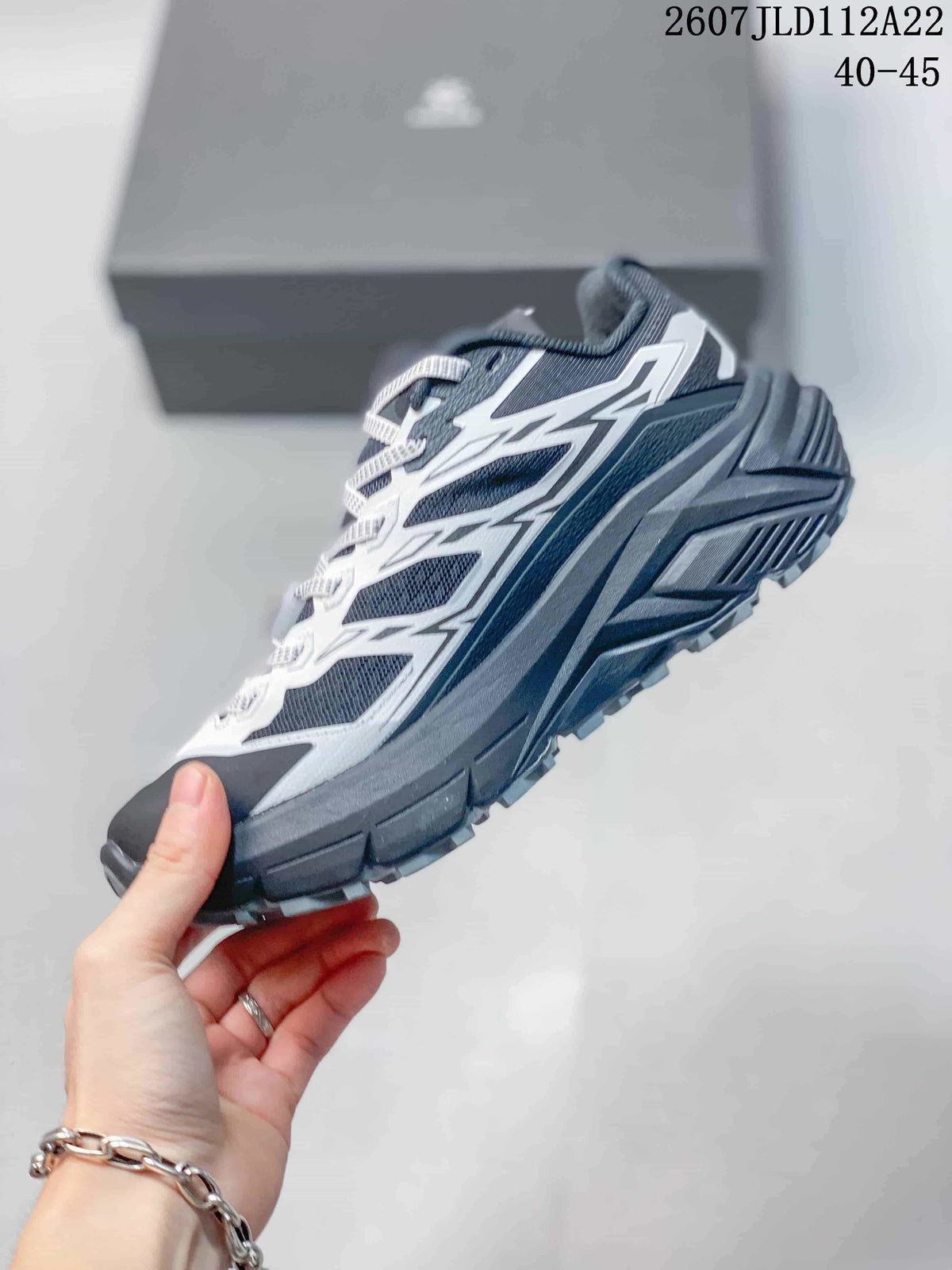 Side profile showing the dark navy mesh upper, white overlays, cushioned midsole, and lugged outsole.