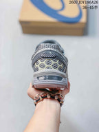 Rear view of the gray and white ASICS sneaker showing the heel construction, textured upper panels, and outsole details.