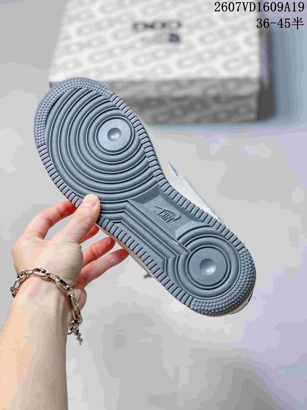 Close-up of the dark blue-gray rubber outsole showing concentric circular traction grooves and Nike Air branding.