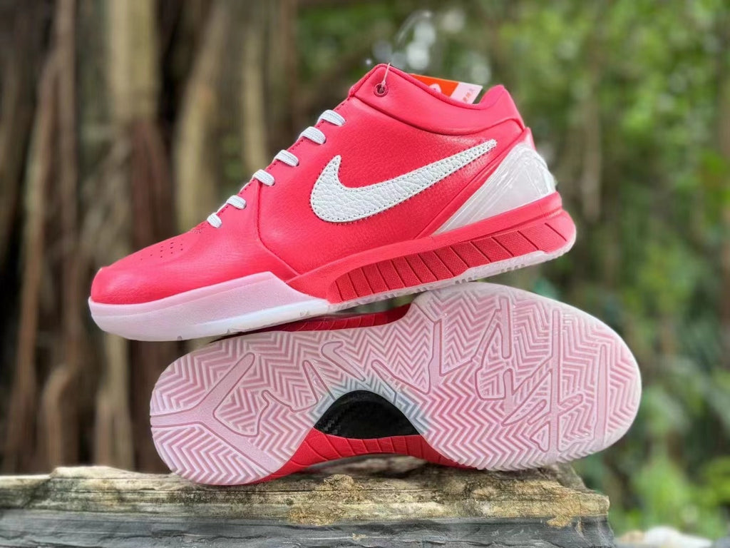 Pink and white Nike Kobe 4 shoes shown from the side with outsole tread visible.