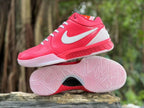 Pink and white Nike Kobe 4 shoes shown from the side with outsole tread visible.
