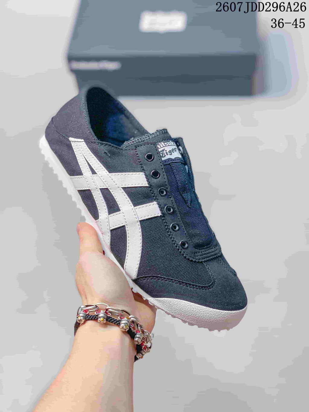 Black and dark gray Onitsuka Tiger Mexico 66 slip-on sneaker with white side stripes and a light outsole.