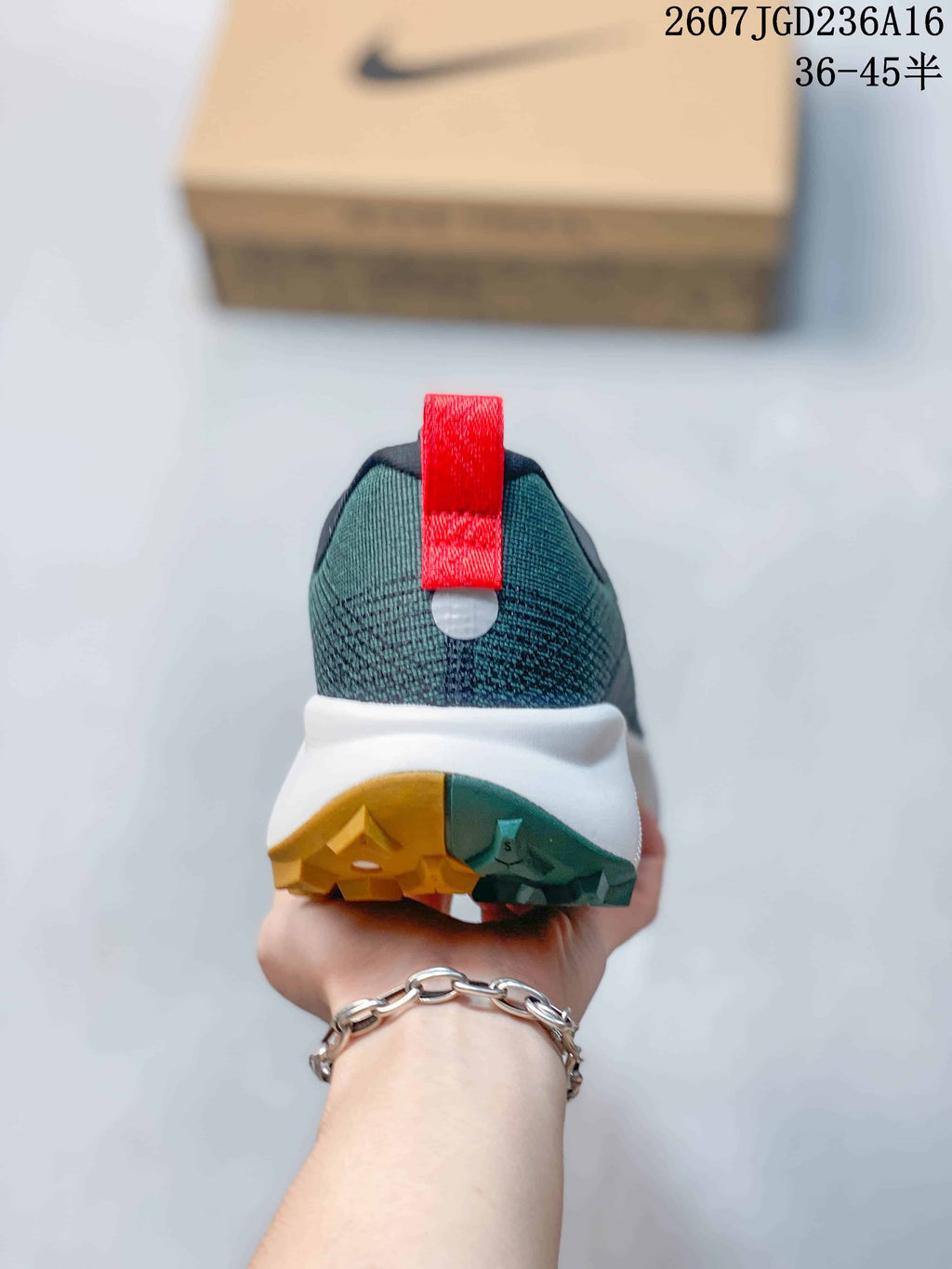 Rear view of the sneaker showing the padded heel, red pull tab, white midsole, and split-color outsole.