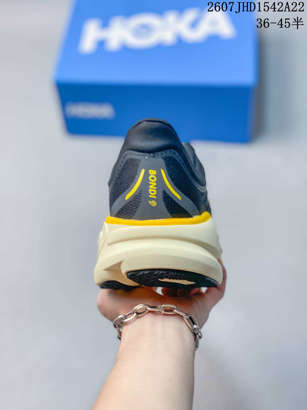 Rear view of a HOKA Bondi 9 sneaker with the model name visible on the heel and a cream midsole.